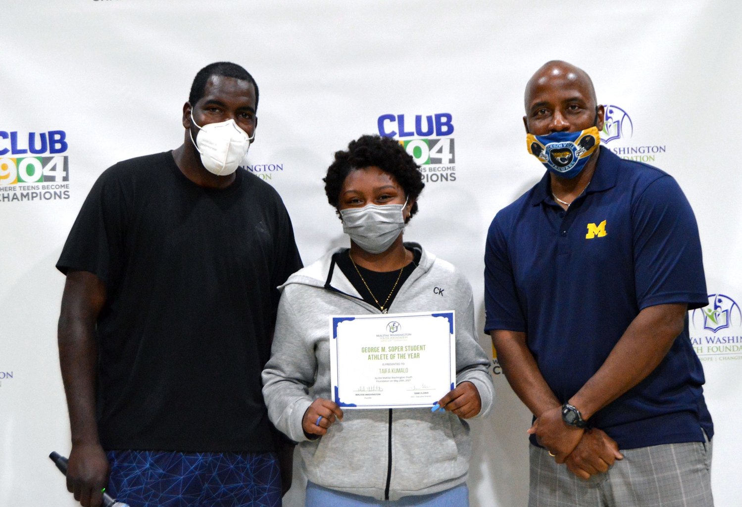 Taifa Kumalo, who received the George M. Soper Student Athlete of the Year Award, stands with foundation tennis director Marc, left, and MaliVai Washington, right.